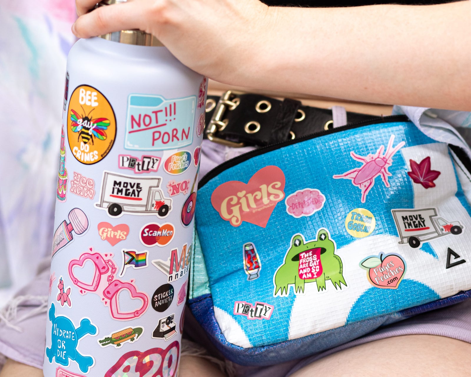 LGBTQ+ and Bright Colored Stickers on a Lavender Water Bottle and Blue Fanny Pack