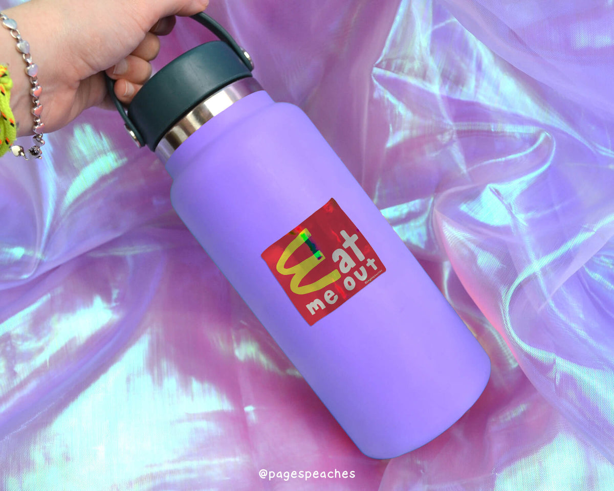 A purple water bottle with a McDonald&#39;s logo on it, held in a hand against a purple background.