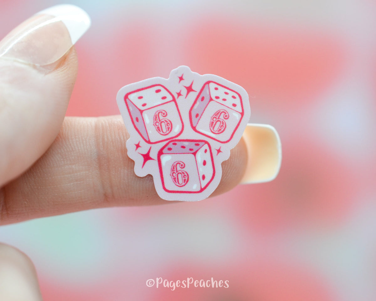 Small Pink Waterproof sticker of 3 Dice with the number 666 on a finger