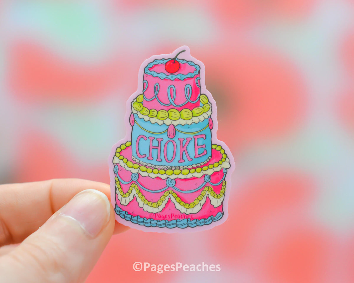 A sticker of a three tiered cake that has choke written on it in icing