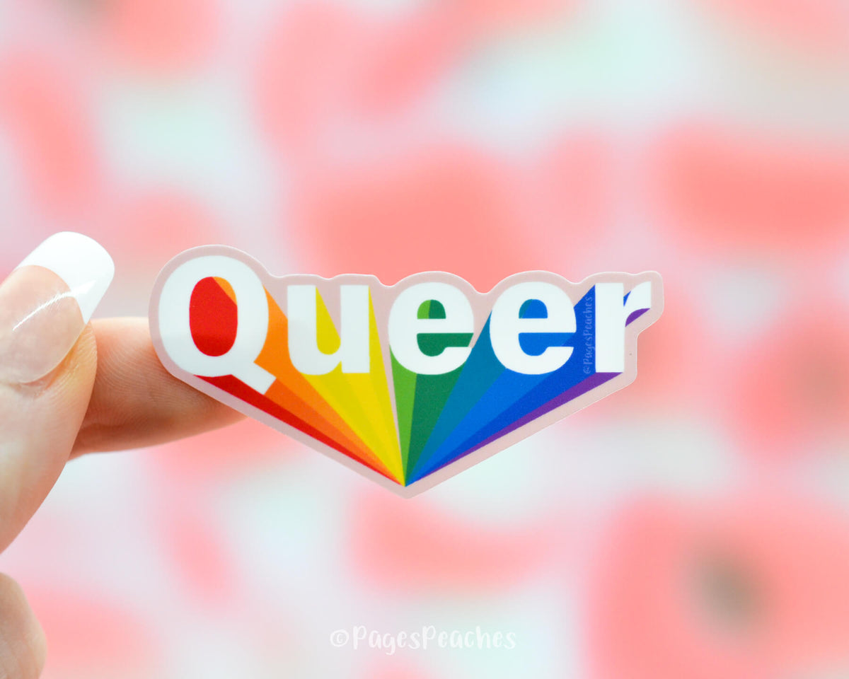 Waterproof sticker that says queer with a rainbow