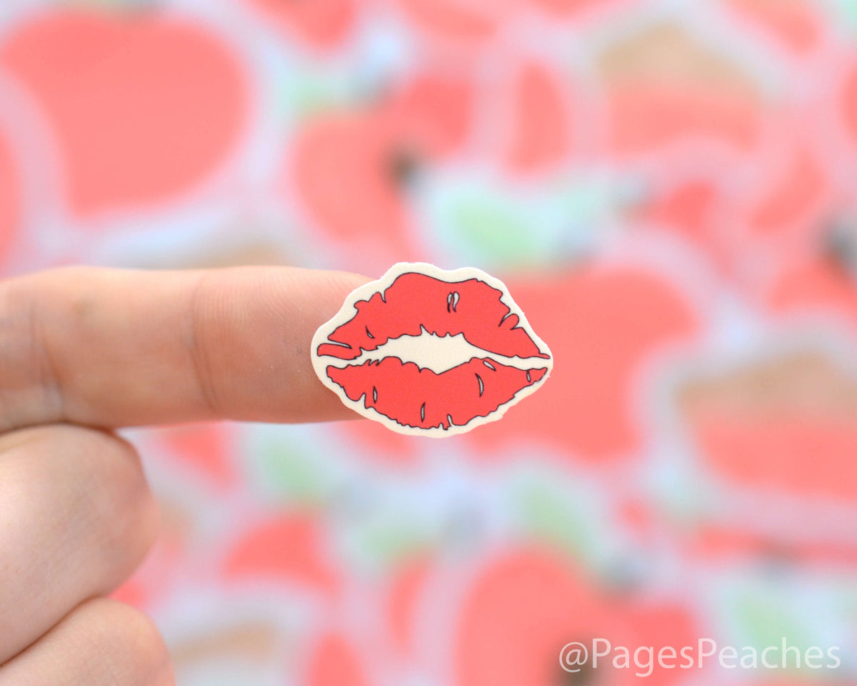 Small Sticker of a red kiss stuck on a finger