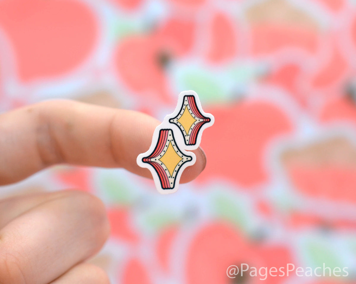 Small Sparkles Sticker stuck to a finger