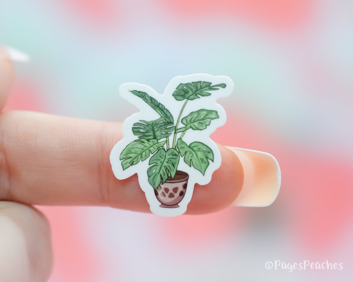 Small Sticker of a Monstera House Plant stuck to a finger