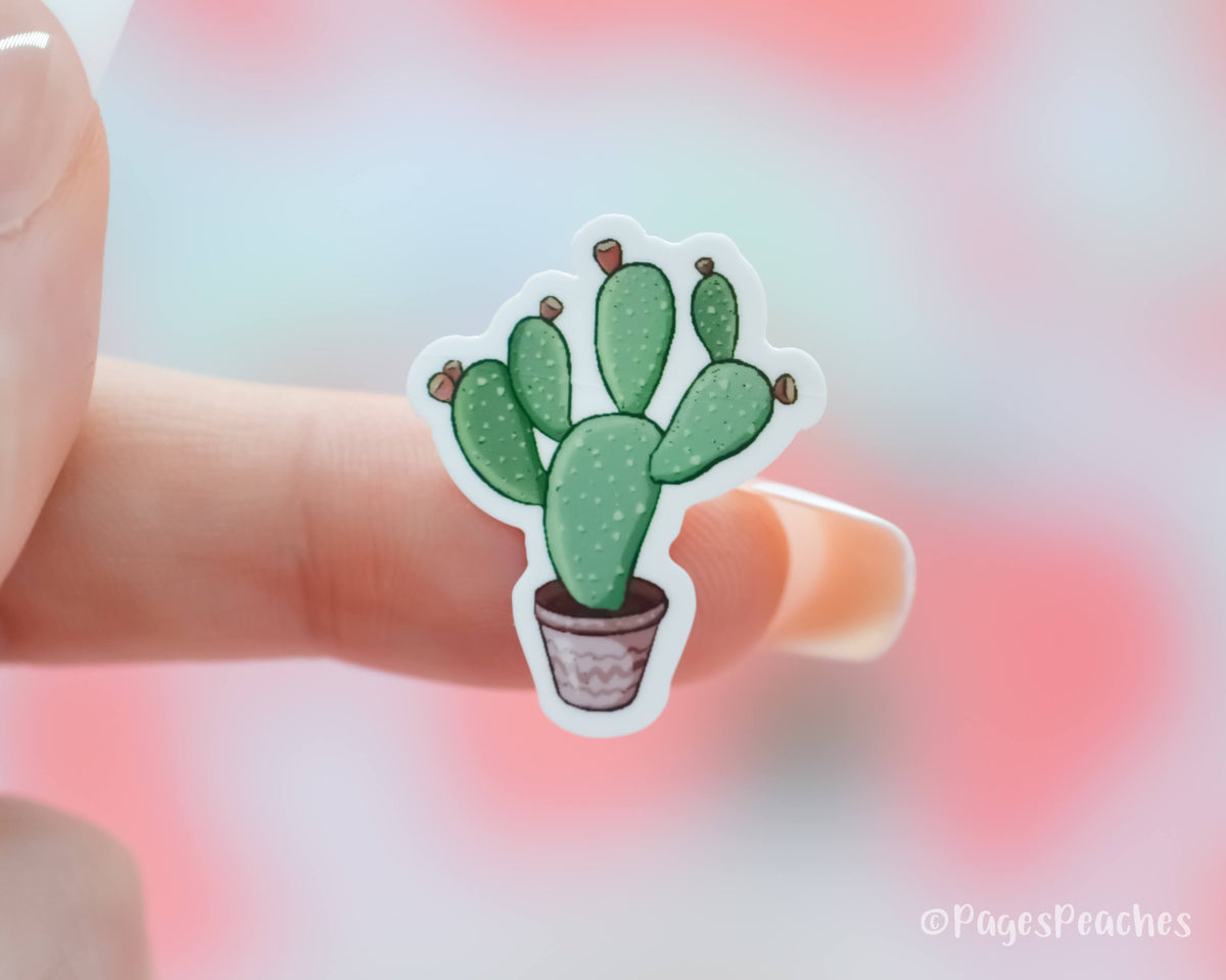 Tiny Sticker of a Prickly Pear Cactus stuck to a finger