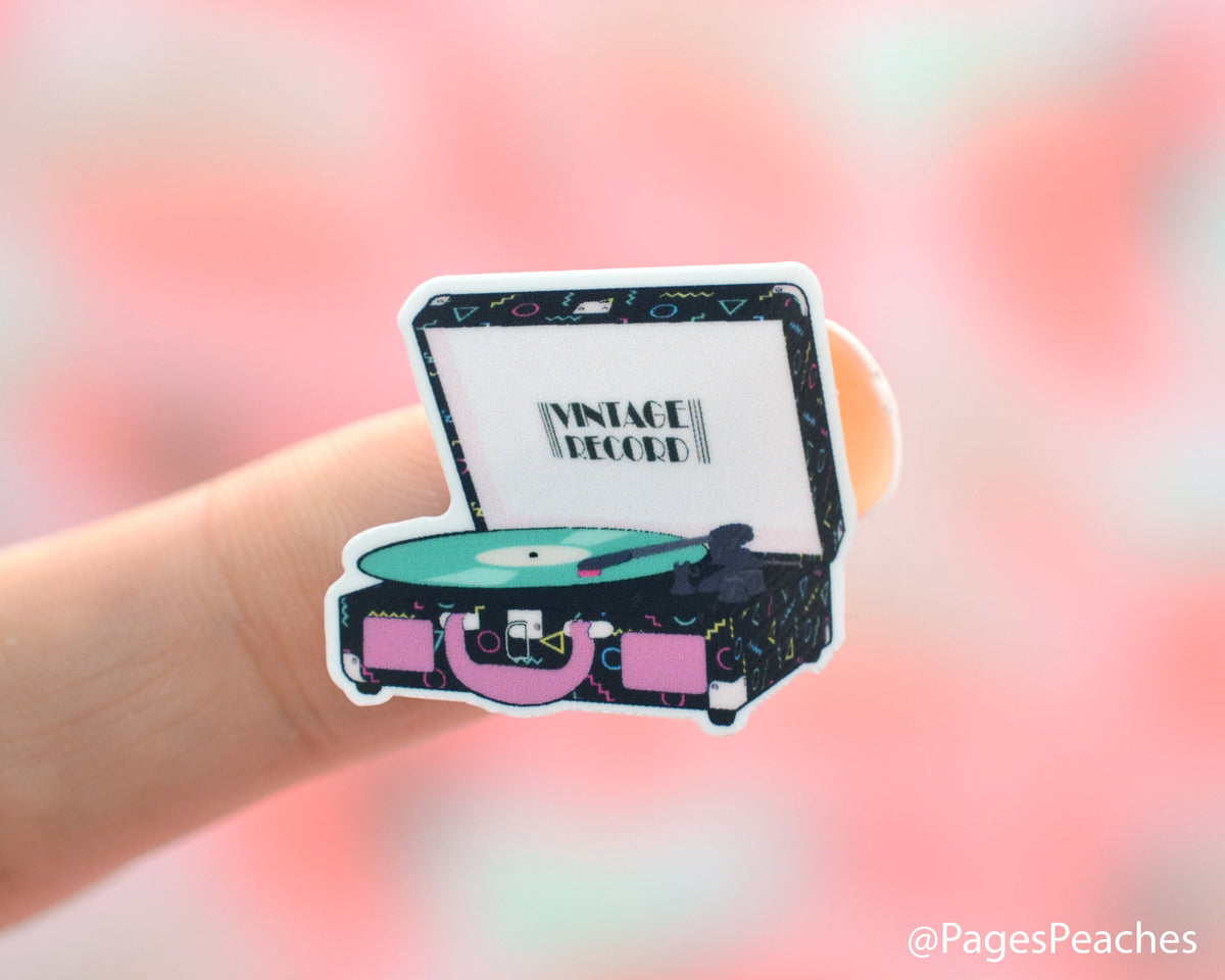 Small Suitcase Record Player Sticker stuck to a finger