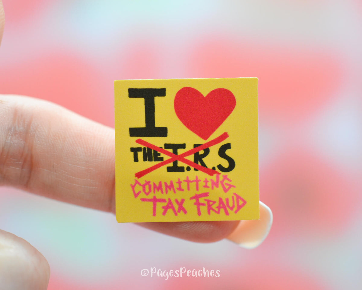 Small Sticker that says I heart committing tax fraud sticker stuck on a sticker